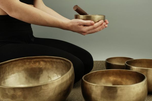 Close-up of a person's hands in a mindful meditation pose.